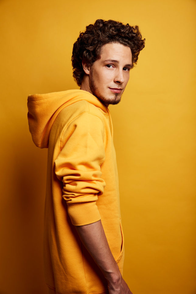 Producer Maxim Schunk in Portrait with yellow hoodie Commercial Photography